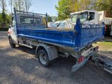 a blue truck that is parked in the dirt