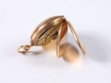 a close up of a gold locke on a white surface