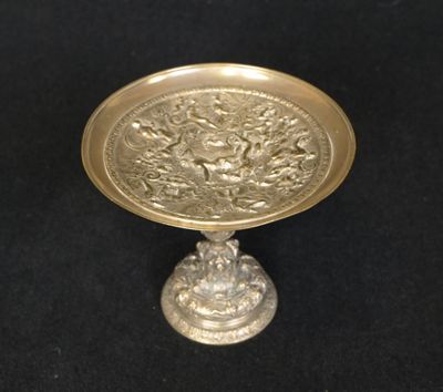 brass plate on a pedestal on a black background