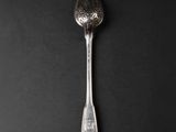 a spoon that is sitting on a black surface