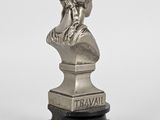 a silver statue of a woman with a head of hair