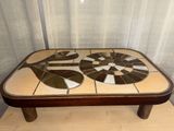 a coffee table with a mosaic design on top of it