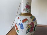 a lamp that is sitting on a table with a lamp shade on it