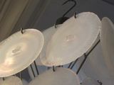 many plates and umbrellas hanging from the ceiling