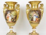 paire de vases en or ornés de peintures sur fond blanc