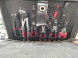 many tools in a case that are sitting on a bed