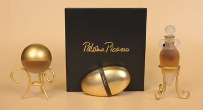 a golden egg next to a black box and a gold egg