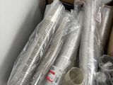 many plastic cups and cups in a box on the floor