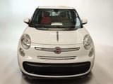 a small white car that is parked in a room