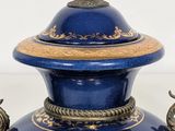 a large blue vase with a gold decoration on it