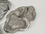 a silver purse sitting next to a pair of silver shoes