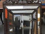 a mirror that is sitting on the floor in front of a table