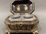 an antique silver and black box with gold decorations on it