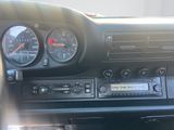 dashboard of a car with gauges, radio, and other electronic equipment