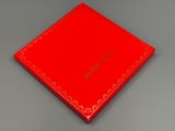 a close up of a red box on a gray surface