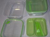 four plastic containers with spoons and forks on a table