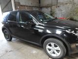 a picture of a black land rover parked in a garage