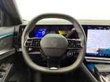 the interior of a car with a steering wheel, dashboard, and display screen