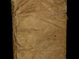 an old book sitting on top of a black surface