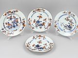 four pieces of blue and white porcelain plates with flowers on them