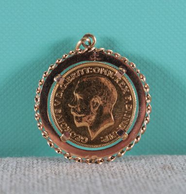 a close up of a coin on a chain with a turquoise background