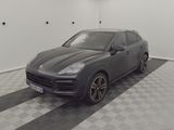 the porsche cayen is parked on a checkered floor in a garage