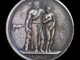 an image of a medal with a man and a woman on it