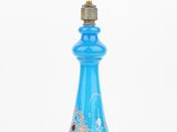 an image of a blue glass perfume bottle with a bird on it