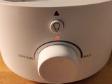 a close up of a white blender on a wooden table