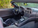 a view of the interior of a sports car from the driver ' s seat
