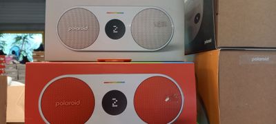 three boxes of different colors and sizes of speakers stacked on top of each other