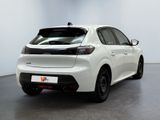 the rear end of a white toyota corollant parked in a room