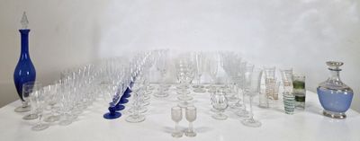 de nombreux verres et vases posés sur une table blanche