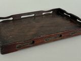 an old wooden tray with handles and handles on a table