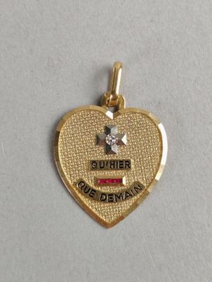 a close up of a heart shaped pendant with a star on it