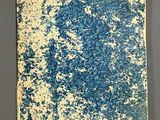 an old blue and white book sitting on top of a table