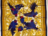 a blue and yellow scarf with birds on it