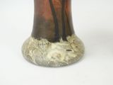 a vase that has a picture of a tree in it