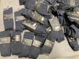 many pairs of black socks on a table