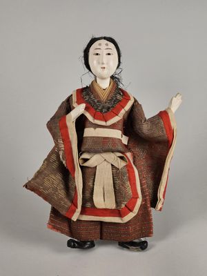 an antique doll of a woman in a kimono