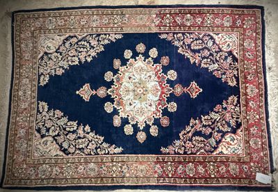 an image of a blue rug with a red border on a floor