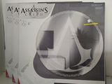 assassin ' s creed game box sitting on a table in a room