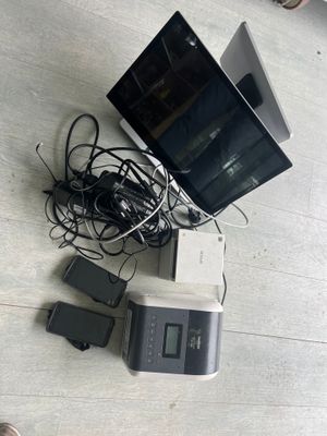a lot of electronics and a laptop on the floor