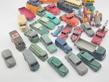 a lot of toy cars and trucks on a white surface