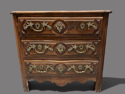 an old wooden chest of drawers with ornate carvings on the drawers