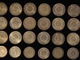 an image of a collection of silver coins on a black background