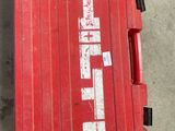 a red box with a sticker on it sitting on the floor