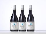 three bottles of wine sitting on top of a table next to each other