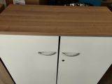 a white cabinet with two doors and a wooden counter top