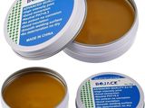 a close up of two tins of lip bales on a white background